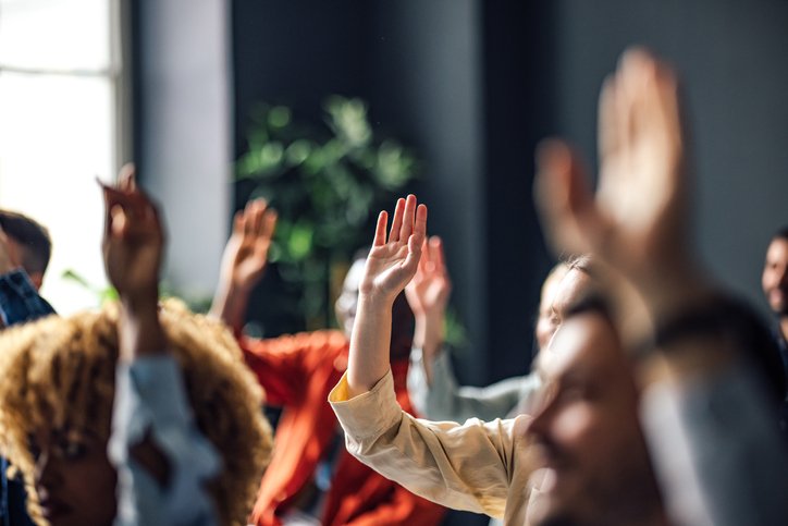 Group of Anonymous People Raising Hands on a Seminar Group of Anonymous People Raising Hands on a Seminar